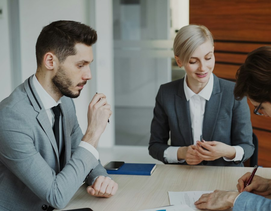 Consultants meeting with a client in a modern office